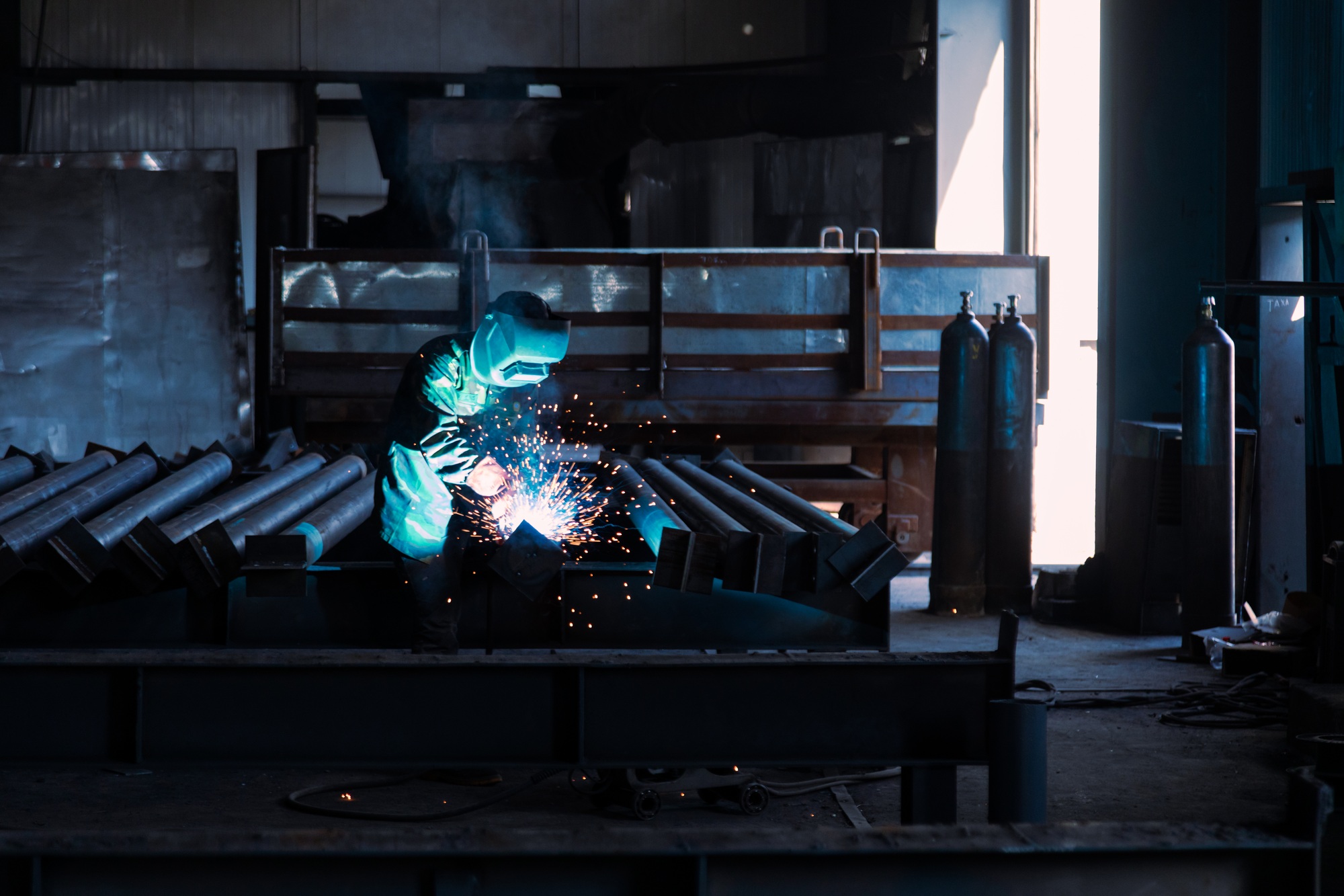 Industrial welder welding metal profiles