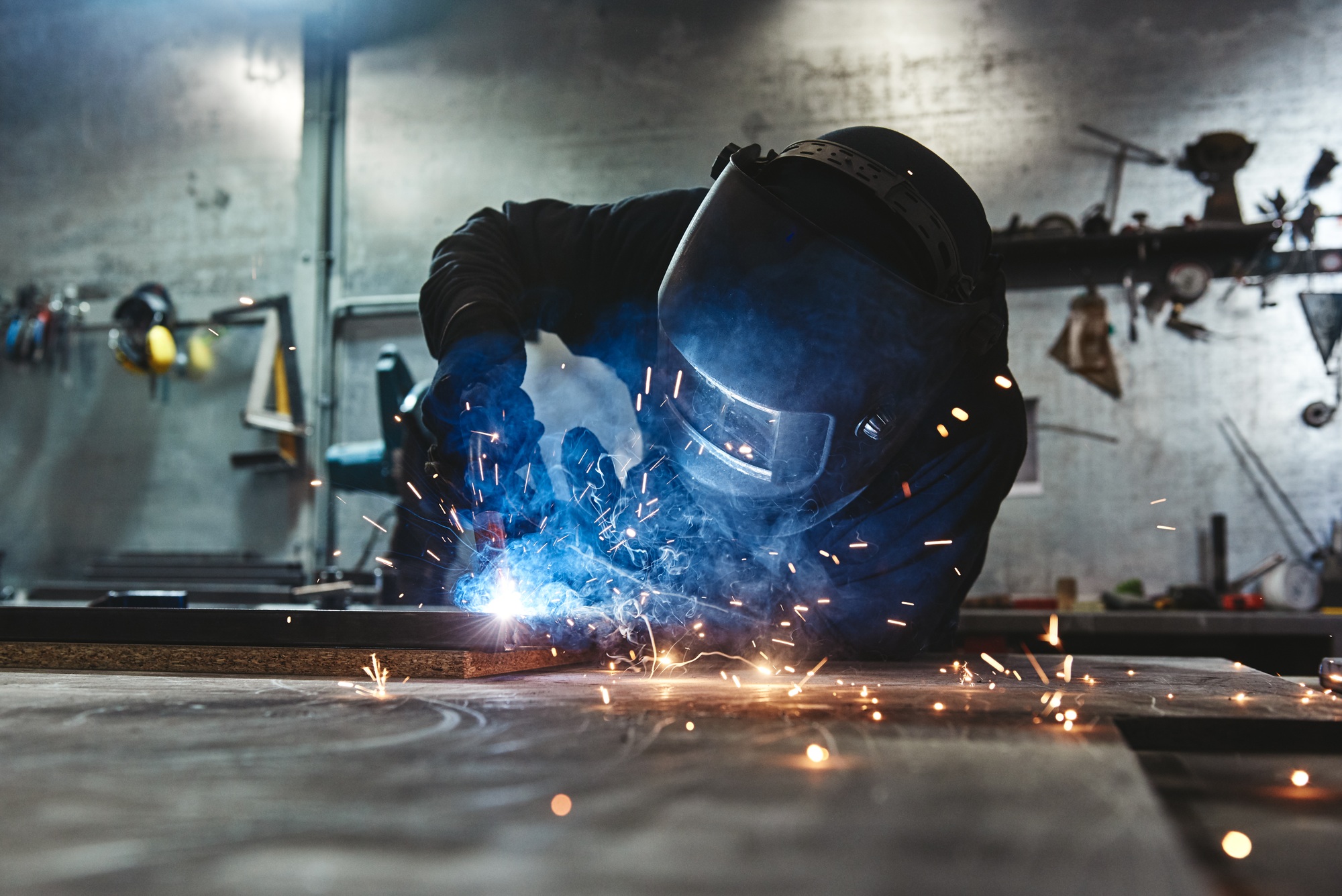 Weld Done Well. Man welds at the factory